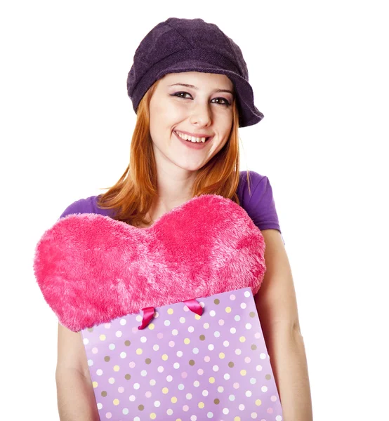 Beautiful red-haired girl with heart in bag. — Stock Photo, Image