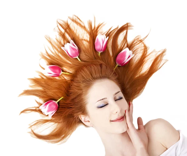 Beautiful red-haired girl with tulips. — Stock Photo, Image