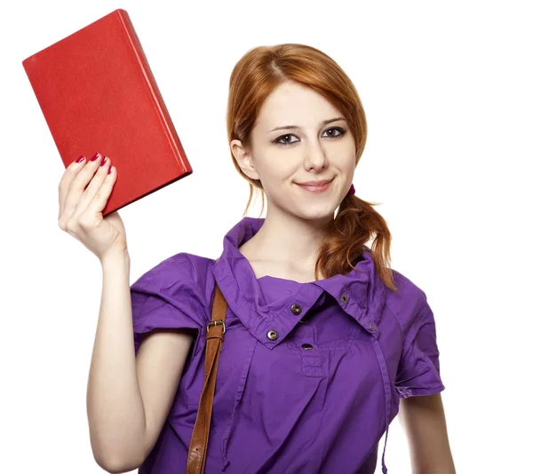 Rudowłosa dziewczyna utrzymać książki w ręku. — Zdjęcie stockowe