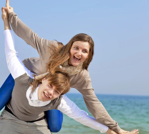 Portrait of a happy young couple having fun on the beach. — Stock Photo, Image