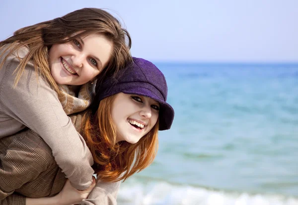 Two happy girls at spring beach. — Stock Photo, Image