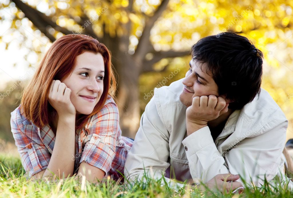 Young couple at grass in the park. — Stock Photo © massonforstock #5187224