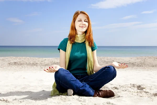 Young beautiful red-haired girl at the beach in spring time. — Stock Photo, Image