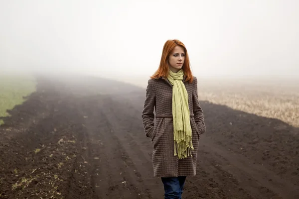Girl at spring field in fog time. — Stock Photo, Image