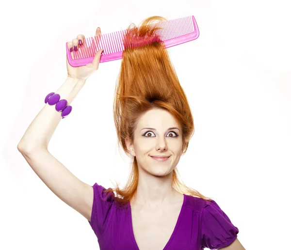 Funny red-haired girl with big comb. — Stock Photo, Image