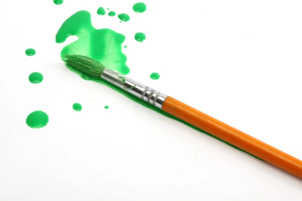 Green paint and brush — Stock Photo, Image