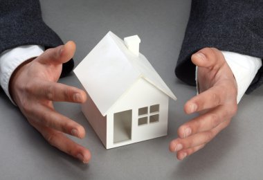 Hands and house model. Real property or insurance concept clipart