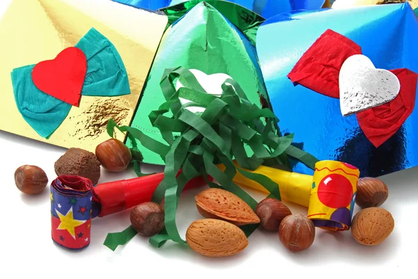 stock image Mixed nuts with party blowers and hats on a plain white background.