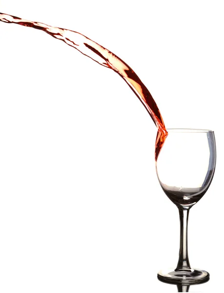 stock image Colored liquid splashing out a glass on a white background