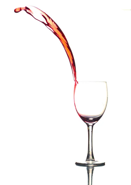 stock image Colored liquid splashing out a glass