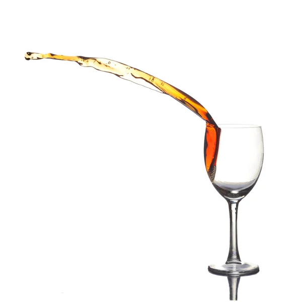 stock image Colored liquid splashing out a glass