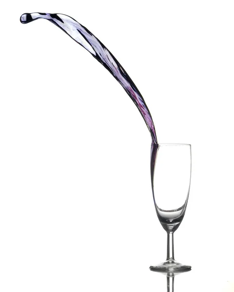 Colored liquid splashing out a glass — Stock Photo, Image