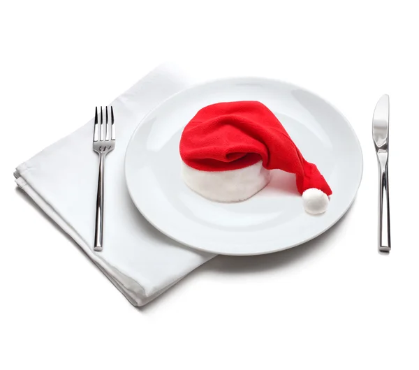 Plate with red santa claus hat — Stok fotoğraf