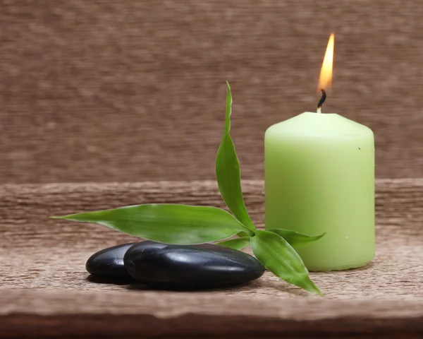 Pebbles and light candle — Stock Photo, Image