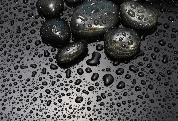 Black stone with water drops — Stock Photo, Image