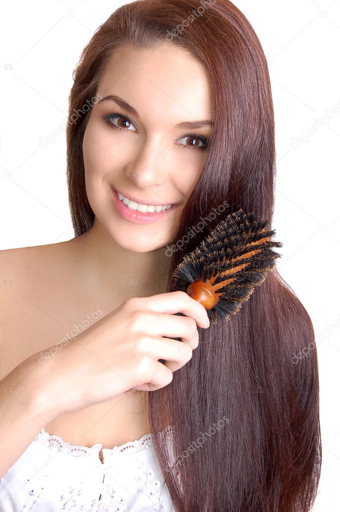 Young woman brushing her long hair