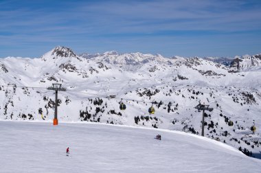 Ski slope with gondola cable car aerial lift, skiing and snowboarding in touristic resort Obertauern Austrian Alps mountain range Austria clipart