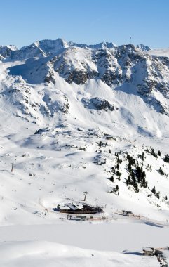 Ski slope with skiing and snowboarding in touristic resort Obertauern in Austrian Alps mountain range in Austria