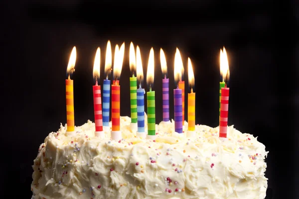 Pastel de cumpleaños y velas sobre fondo negro — Foto de Stock