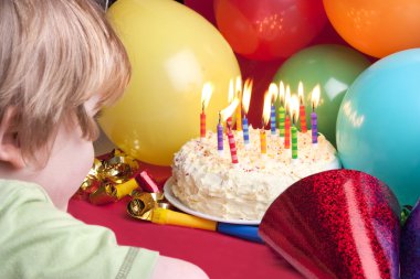 Child blowing candles out clipart