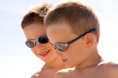 Two Young children on the beach clipart