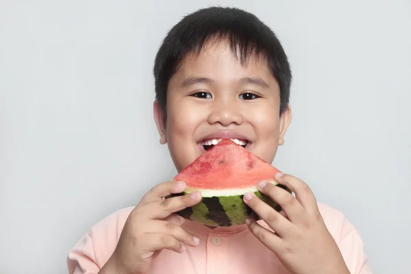 Boy eating a slice of watermelon — Stock Photo, Image