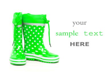 Green rubber boots for kids isolated on white background (with space for text) clipart