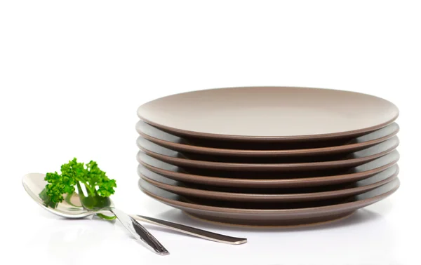 Plates, fork, spoon and parsley — Stock Photo, Image