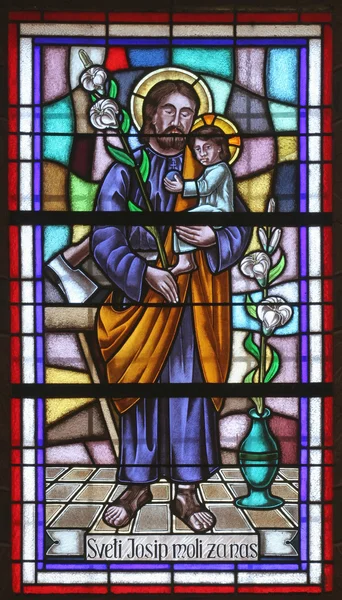 Saint joseph gospodarstwa Jezusa dziecka — Zdjęcie stockowe