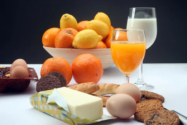 Breakfast with juice, milk, fruits and eggs — Stock Photo, Image