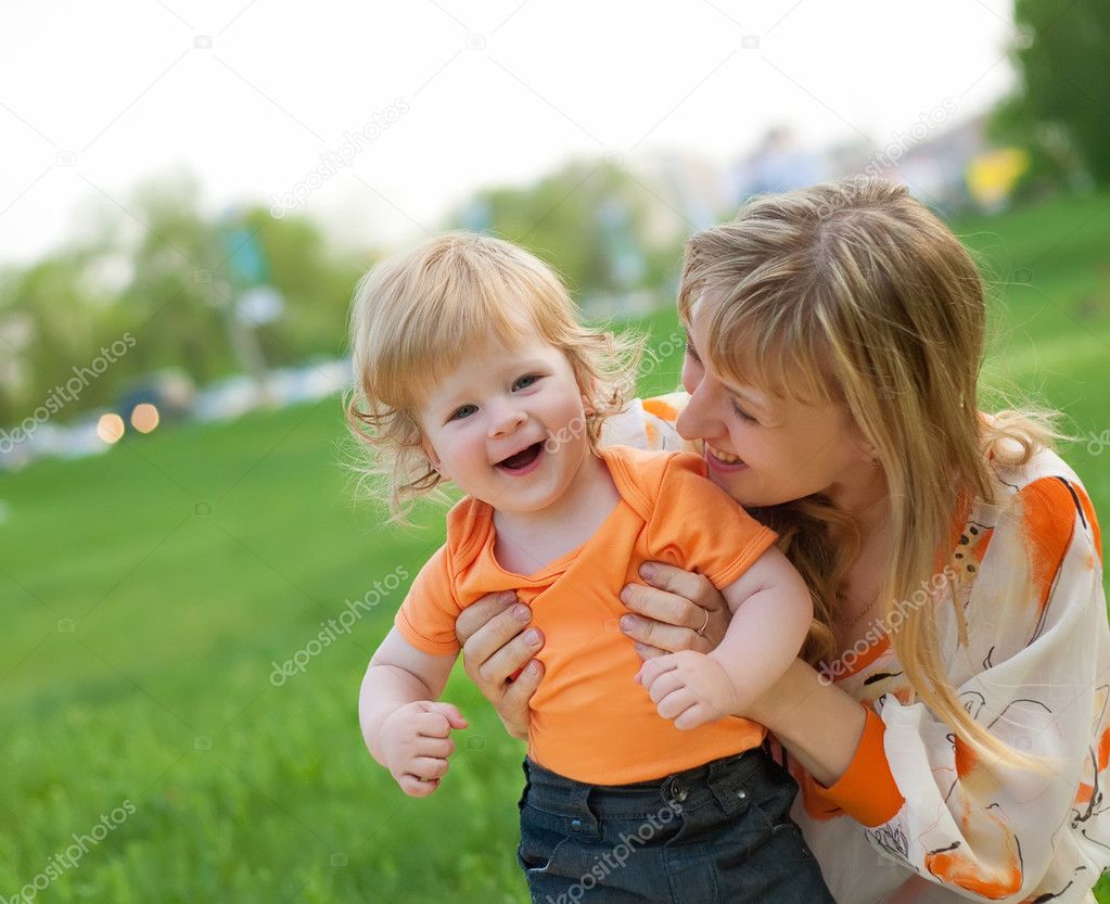 Happy mother and her little son outdoors session