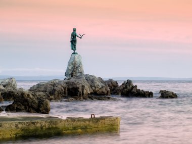 This historic statue on the Adriatic coast is a symbol of touristic town Opatija in Croatia. clipart