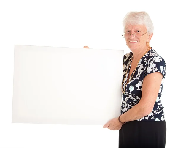 Boş bir tabela holding üst düzey iş kadını — Stok fotoğraf