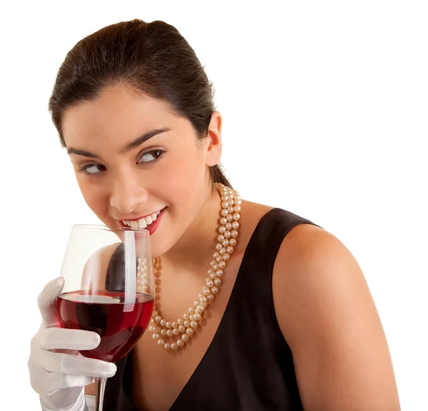Frau hält Glas Wein in der Hand und schaut zur Seite lizenzfreie Stockbilder