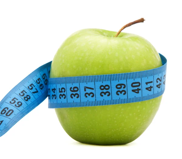 Zelené jablko s centimetr — Stock fotografie