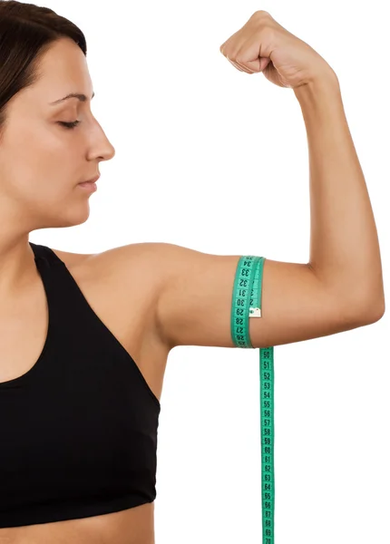 Mujer midiendo su brazo — Foto de Stock