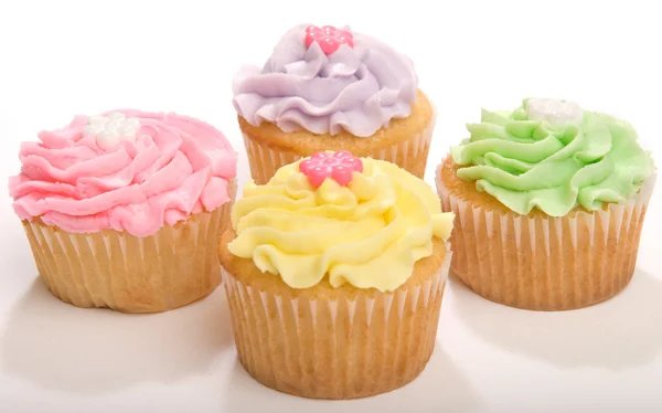 Vier Pastell-Cupcakes lizenzfreie Stockfotos