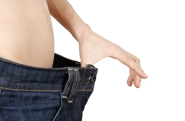 Štíhlá žena ve velkých džíny — Stock fotografie