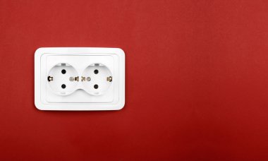 Power outlet on red wall clipart