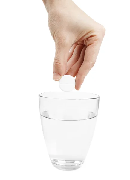 Pastillas de efervescencia y un vaso de agua — Foto de Stock