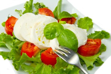 Mozzarella with tomtoes and basil clipart