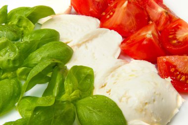 Mozzarella with tomtoes and basil clipart