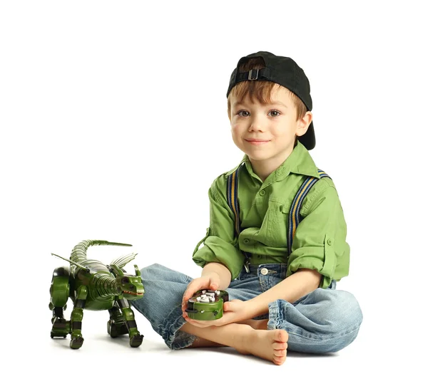 Junge spielt mit Dinosaurier — Stockfoto