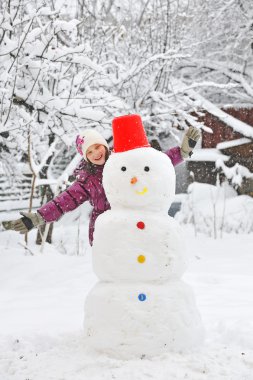 Snowman and young girl clipart