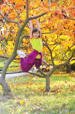 Little girl climbed on tree clipart