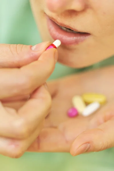 Woman taking pills — Stock Photo, Image