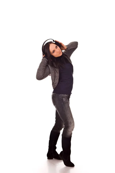 Cute woman listens to music with headphones — ストック写真