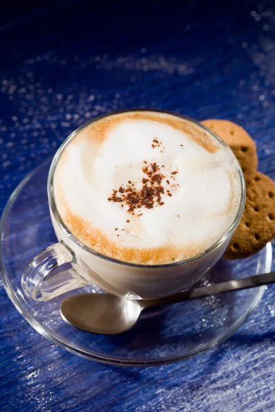 Cappuccino on blue glass table — Stock Fotó