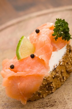 Slice of Bread with creme fraiche and smoked salmon clipart