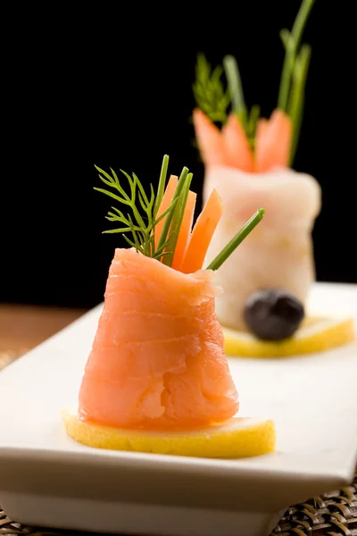 Smoked Salmon rolls with tomatoes — Stock Photo, Image
